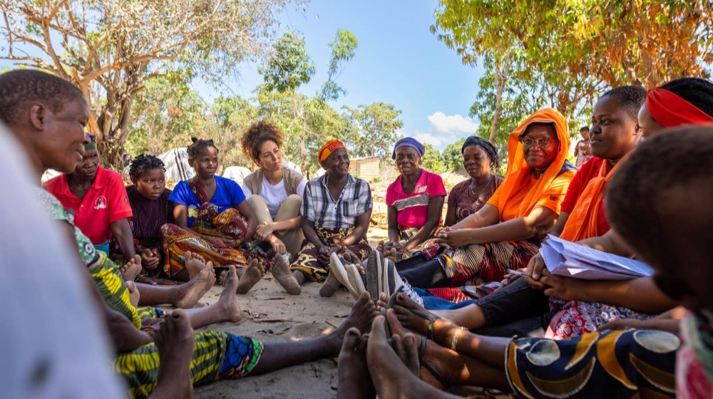 Regional Director Lydia Zigomo sits down with women in Mozambique. 