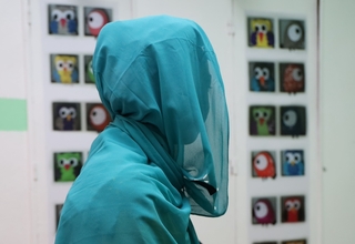 Young woman with her head covered.