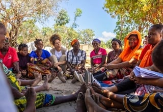 Regional Director Lydia Zigomo sits down with women in Mozambique. 