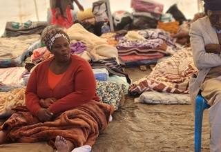 A woman waits to be profiled in a temporary shelter on Magwaveni sports field.