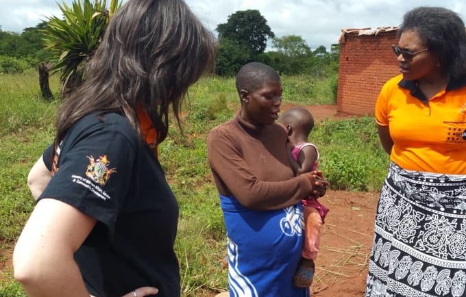 UNFPA Zimbabwe colleagues Rose Katumba and Verena Bruno listen to a pregnant survivor of Cyclone Idai in Chipinge as she narrates how her antenatal care records and medication were swept away by the floods. © UNFPA Zimbabwe