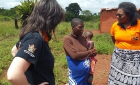 UNFPA Zimbabwe colleagues Rose Katumba and Verena Bruno listen to a pregnant survivor of Cyclone Idai in Chipinge as she narrates how her antenatal care records and medication were swept away by the floods. © UNFPA Zimbabwe
