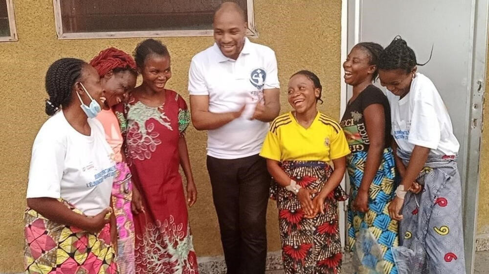 Pemba (in yellow top) and other patients with senior surgeon Dr. Lucien Wasingya Kasereka of FisPro DRC, a UNFPA partner that tr