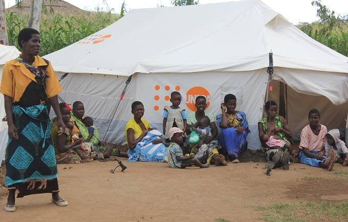 A group of lactating mothers relaxes outside a tent used as a 'safe space’ for women and girls at Mpasa camp in Phalombe, Malawi. Photo: UNFPA Malawi