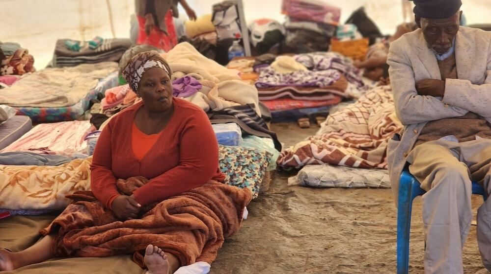 A woman waits to be profiled in a temporary shelter on Magwaveni sports field.