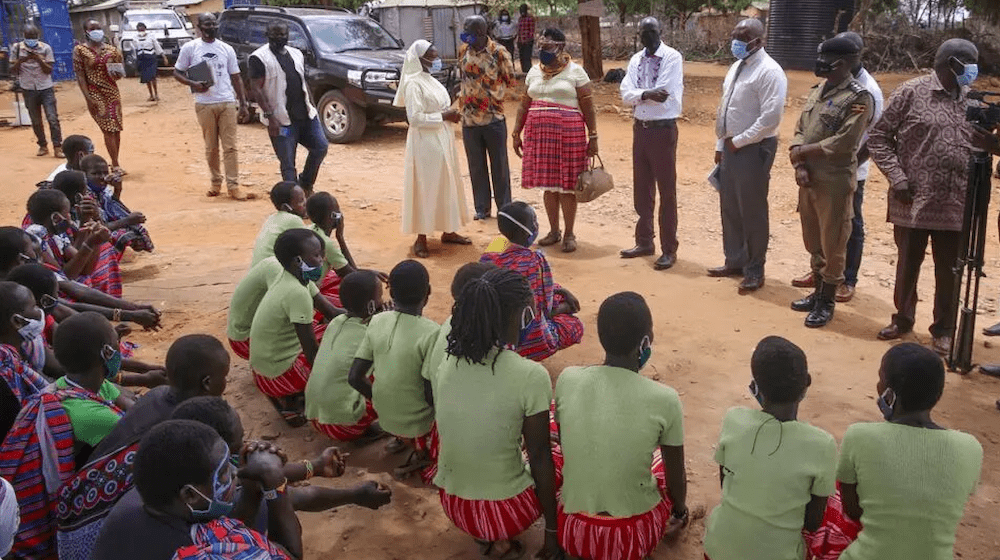 A delegation of  state ministers and district leaders speak with girls at the Kalas primary school in Amudat.